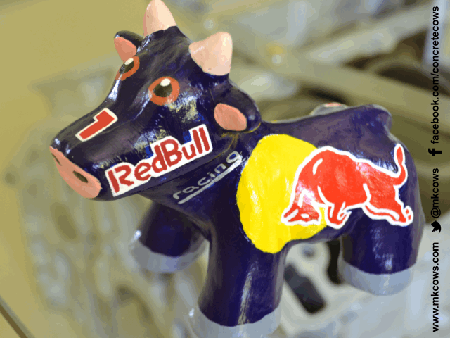 Special edition Mini Concrete Cow painted with the RedBull logo all over it